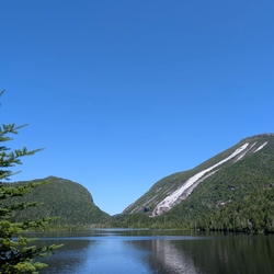 Lake Colden on a clear Summer day reflecting the mountains and deep blue sky.