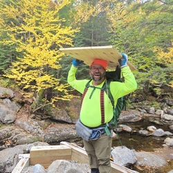 Adam and the group carrying supplies across indian  pass brook
