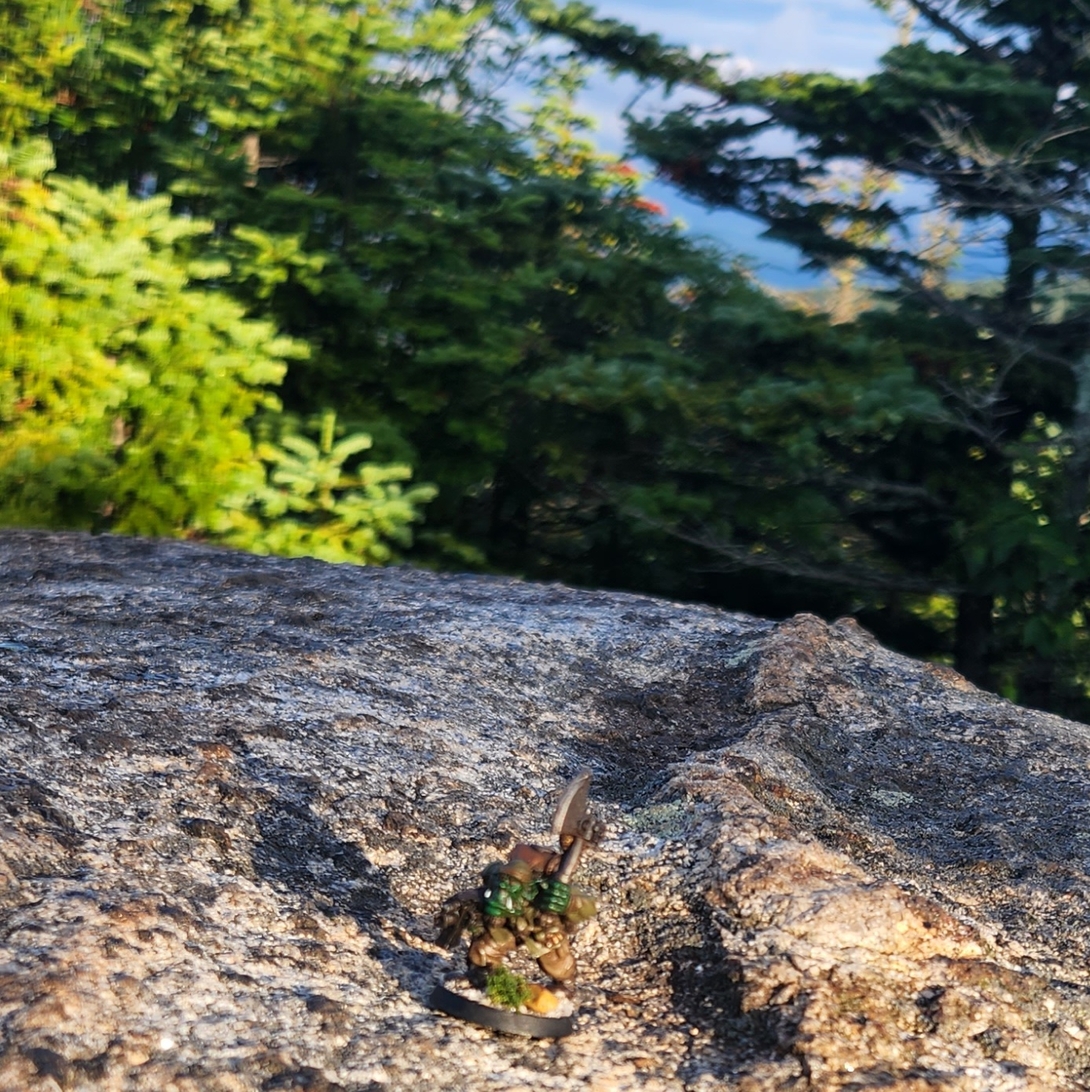 The Adirondack Kommando figurine stands on a rocky ledge at Porter Mountain’s summit.