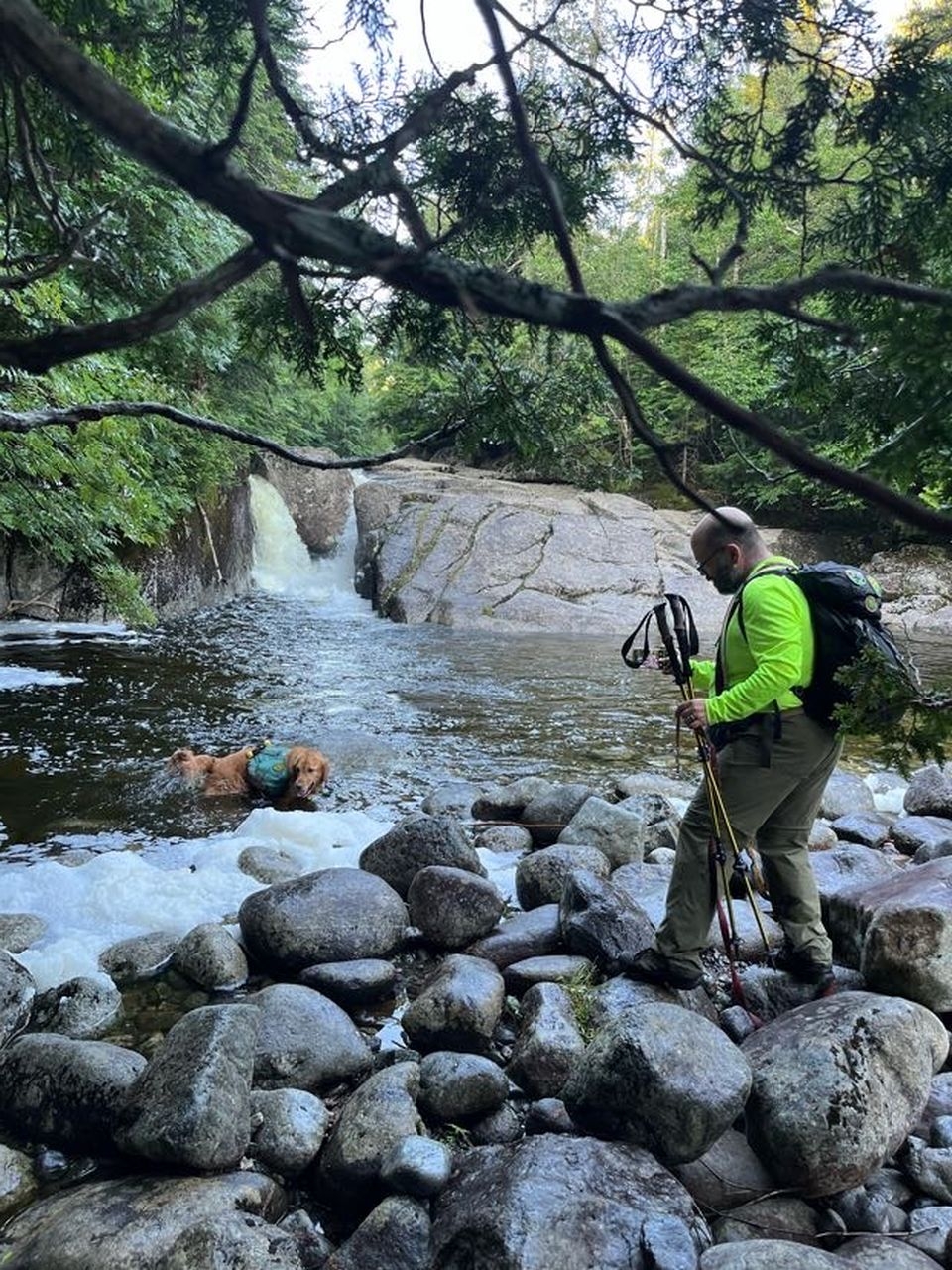 adam taking a picture of sunny swimming at rocky falls